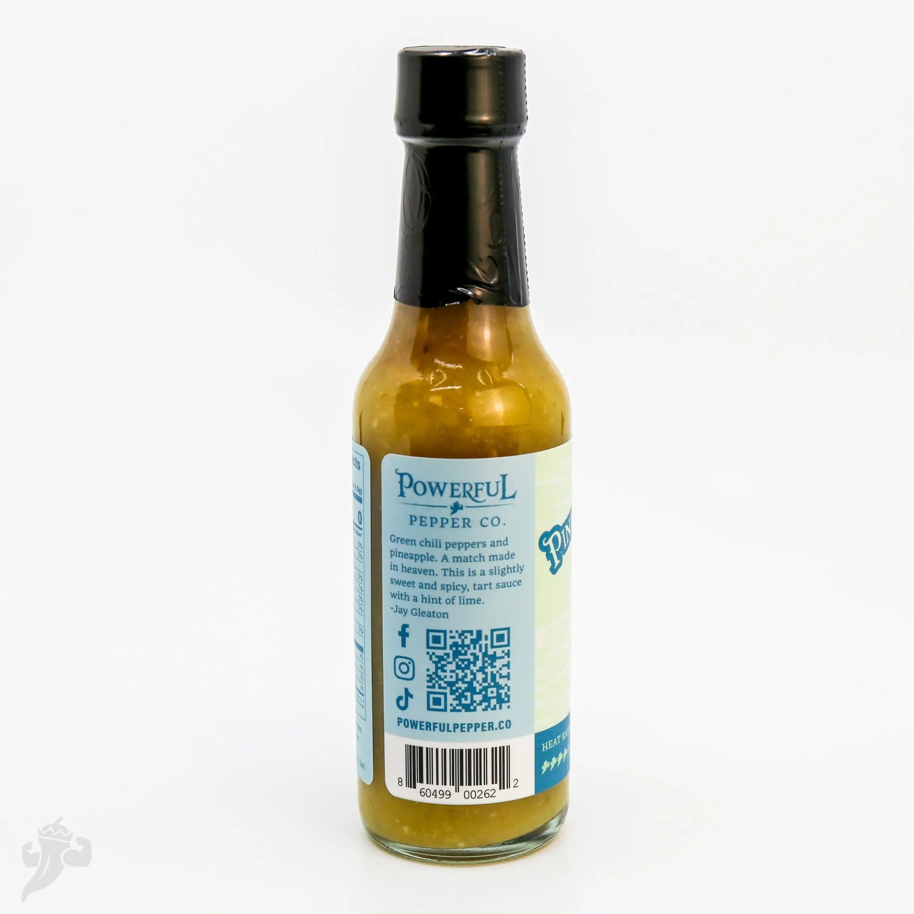 Serrano Pineapple Hot Sauce from Powerful Pepper Co. featuring green chili peppers.