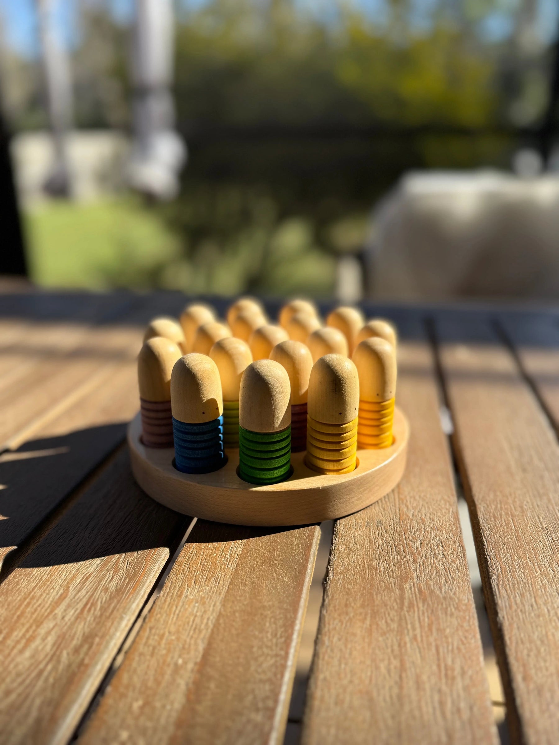 Wooden sorting tray with colorful pegs, designed for Grapat Brots play pieces.