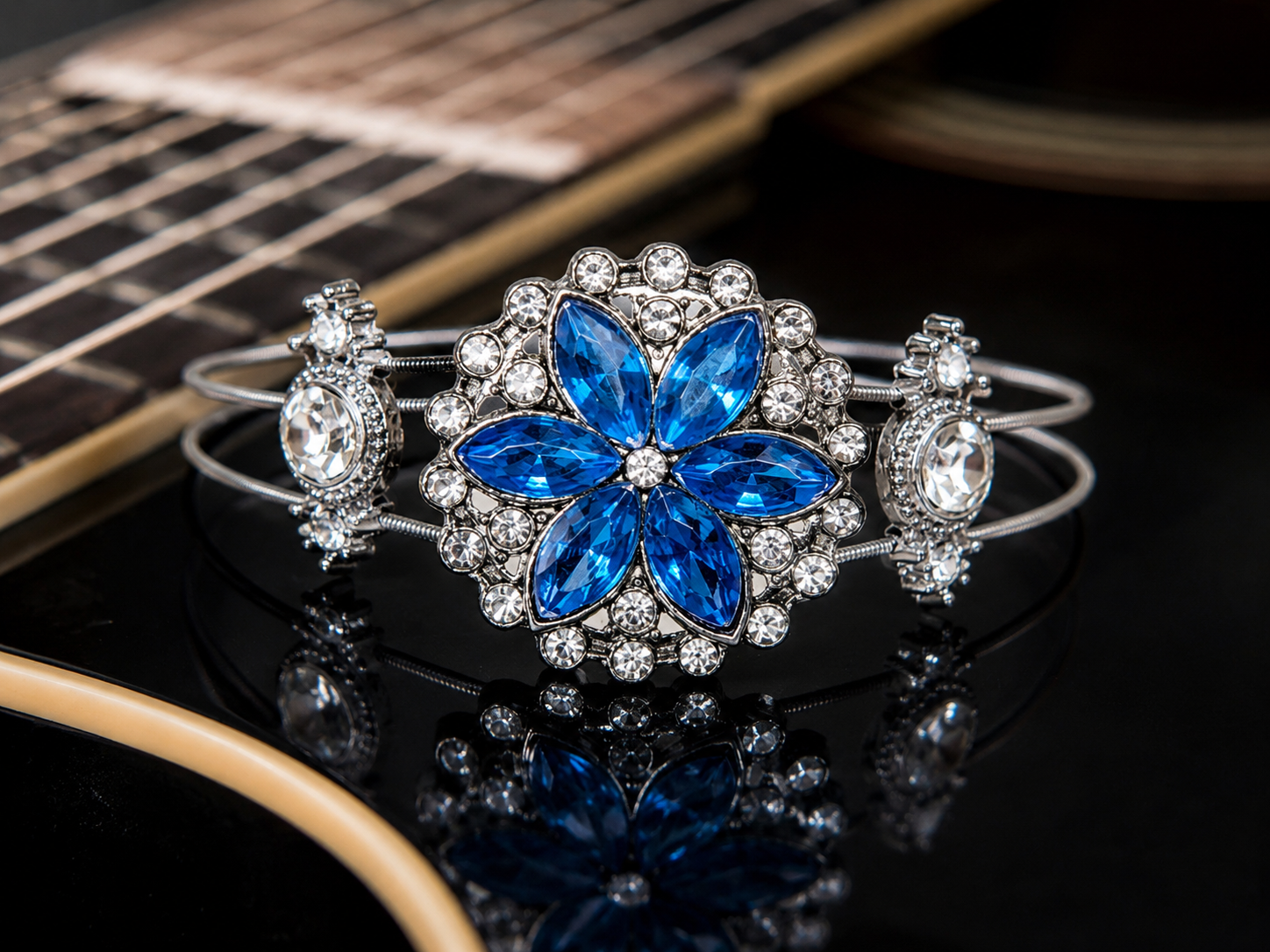 Blue rhinestone flower guitar string bracelet on guitar