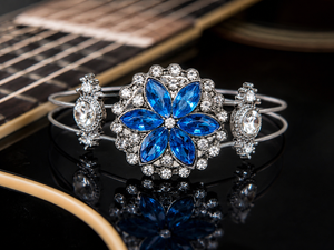 Blue rhinestone flower guitar string bracelet on guitar