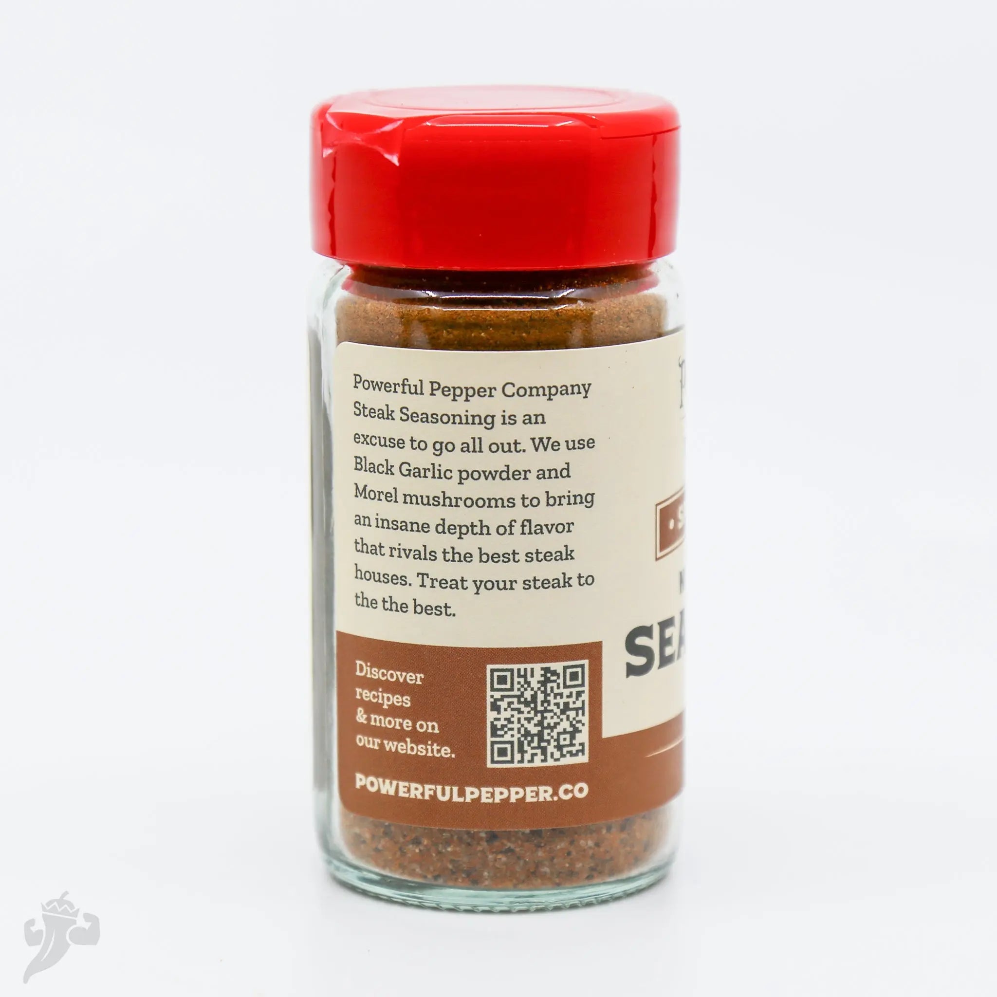 Powerful Pepper Company Steak Seasoning in a glass jar with a red lid.