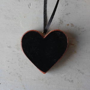 Black heart ornament made from reclaimed Steinway piano wood with a black ribbon hanger.