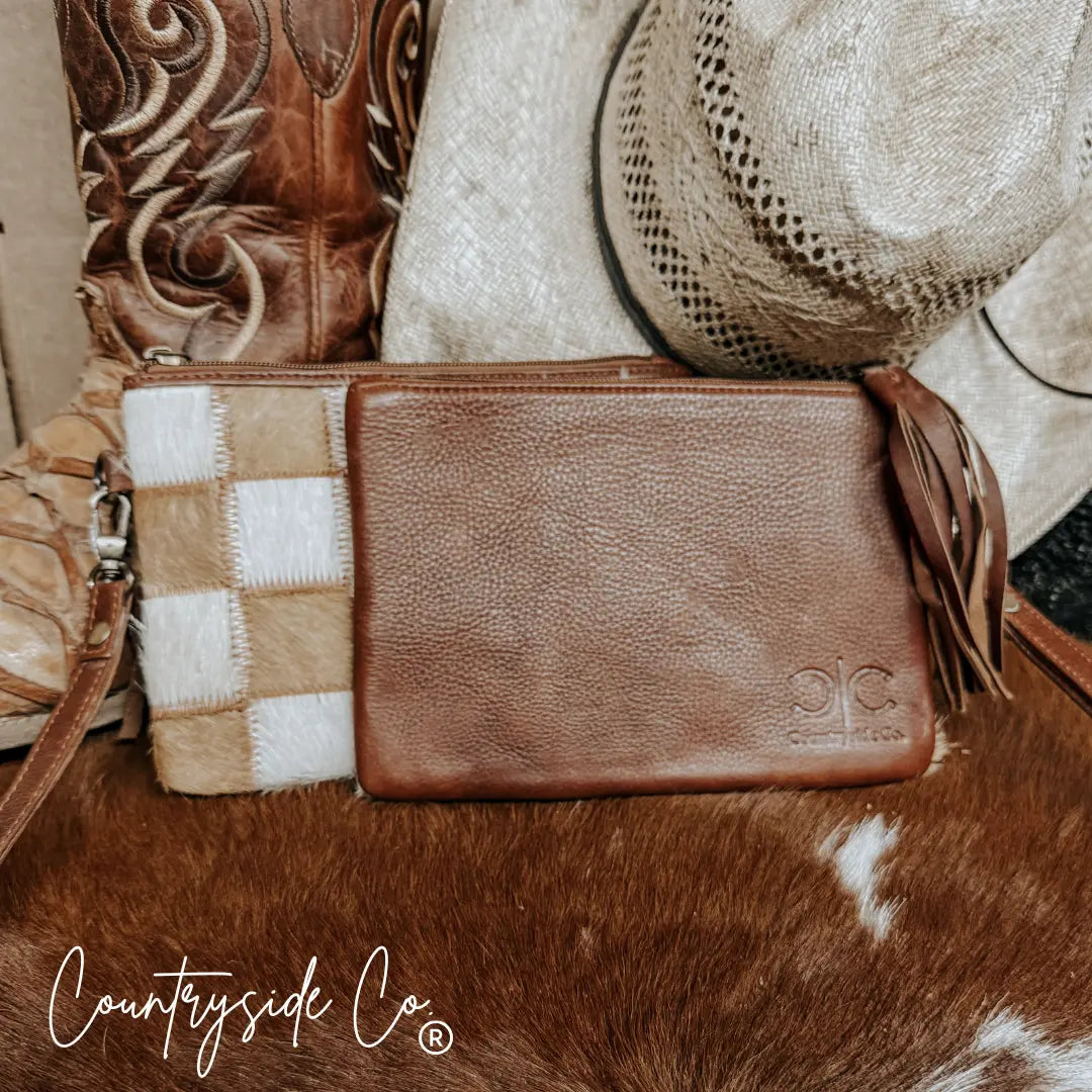Stockdale checkered cowhide wristlet pouch with leather fringe detail.