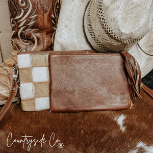 Stockdale checkered cowhide wristlet pouch with leather fringe detail.