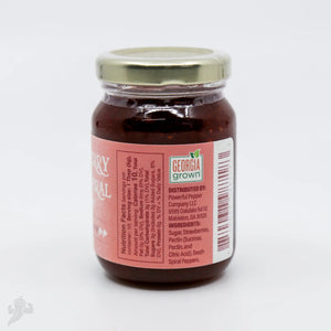 Strawberry Death Spiral Chili Jam in a glass jar with a gold lid.