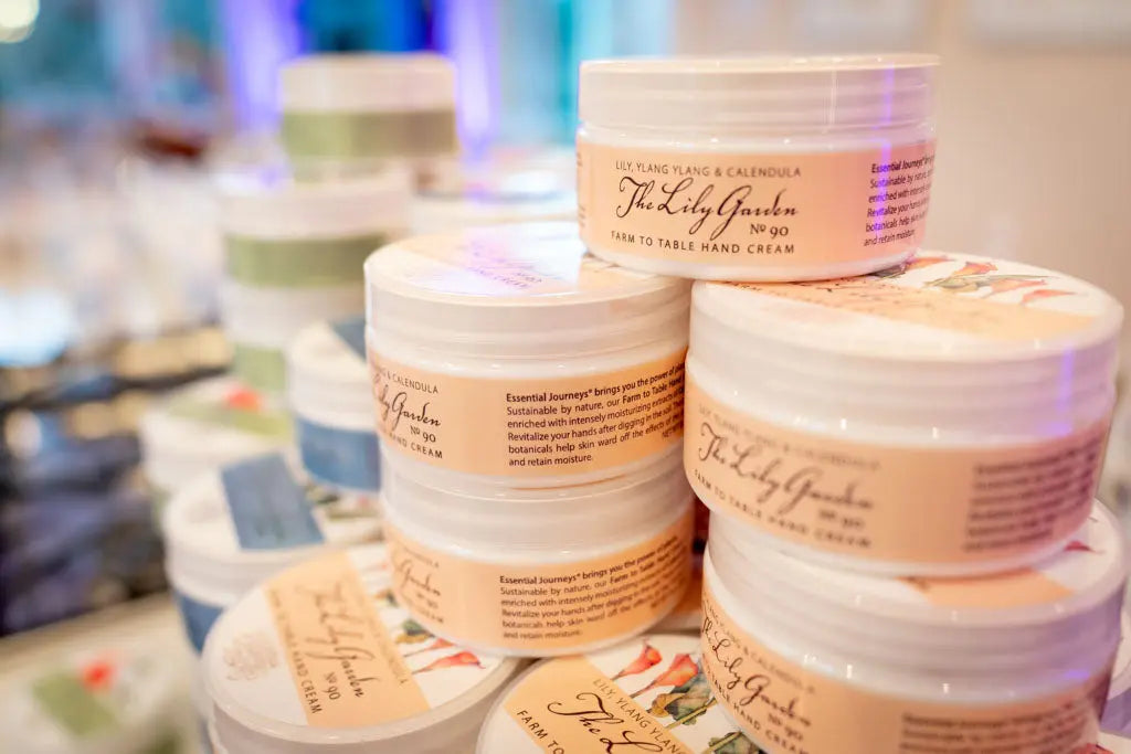 Jars of The Lily Garden Farm to Table Hand Cream with LILY, YLANG YLANG & CALENDULA labels.