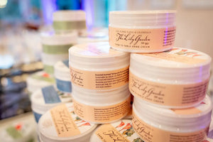 Jars of The Lily Garden Farm to Table Hand Cream with LILY, YLANG YLANG & CALENDULA labels.