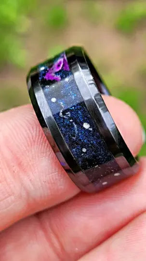Black ceramic ring with embedded ashes, black onyx mica, purple glow, star constellations, and cremated ashes.