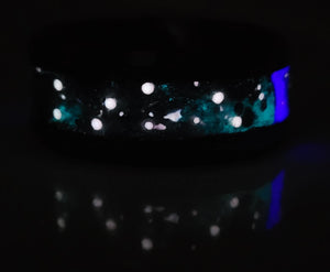 Big Dipper memorial ring: black ceramic band with ashes, glow-in-the-dark stars, and blue accent.