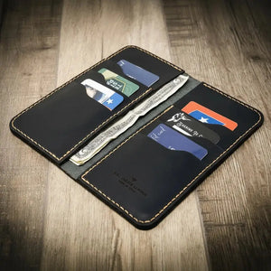 Black leather long wallet with multiple card slots and cash compartment.