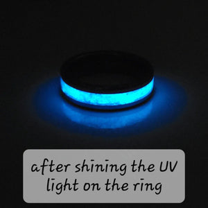 Glowing blue ring illuminated by UV light. Dark band with bright blue center.
