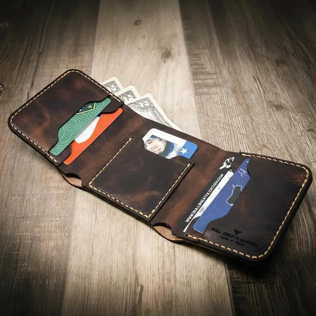 Brown leather trifold wallet with cards and cash inside.