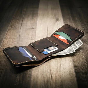 Brown leather trifold wallet open with credit cards and cash visible