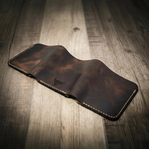 Brown leather trifold wallet with embossed bull logo and hand stitching