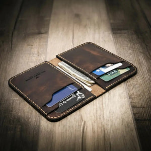 Brown leather vertical wallet with card slots and cash pockets.