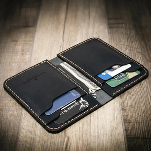 Black leather minimalist vertical wallet with card slots and cash pocket