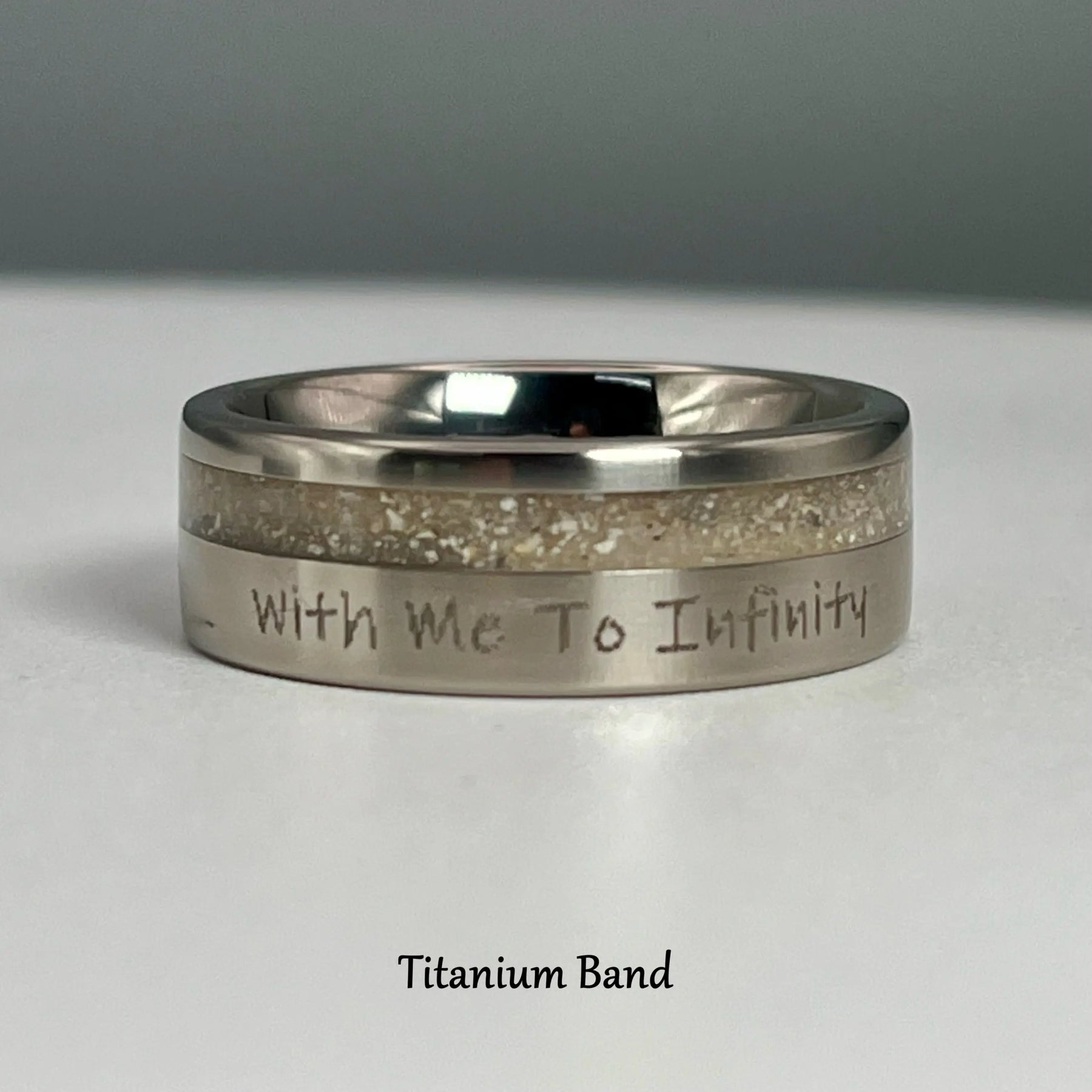 Titanium memorial ring with sand/ashes inlay and the inscription "With Me To Infinity"