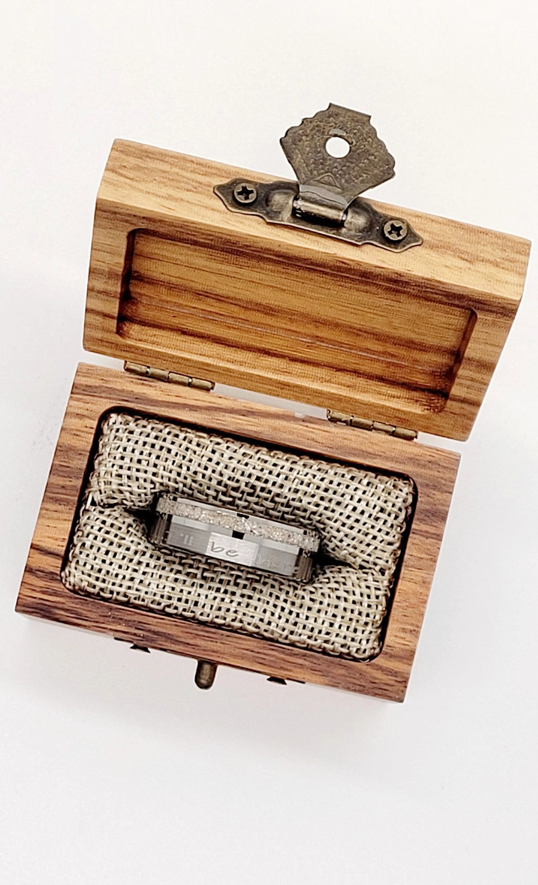 Tungsten memorial ring with ashes inlay in a wooden box with metal clasp.