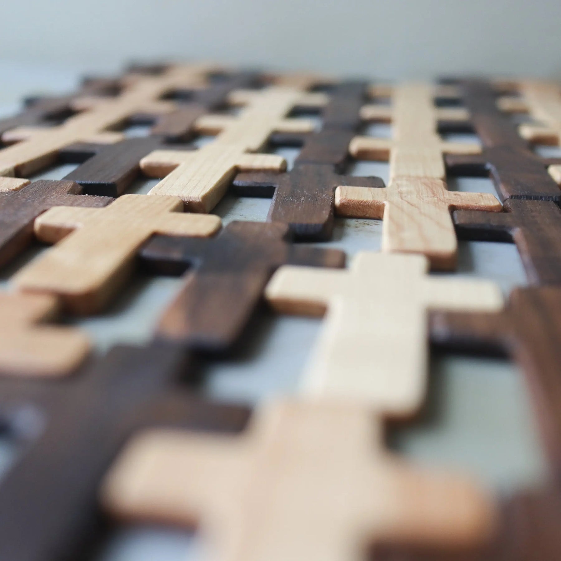 Two-tone wooden crosses with an interlocking pattern.