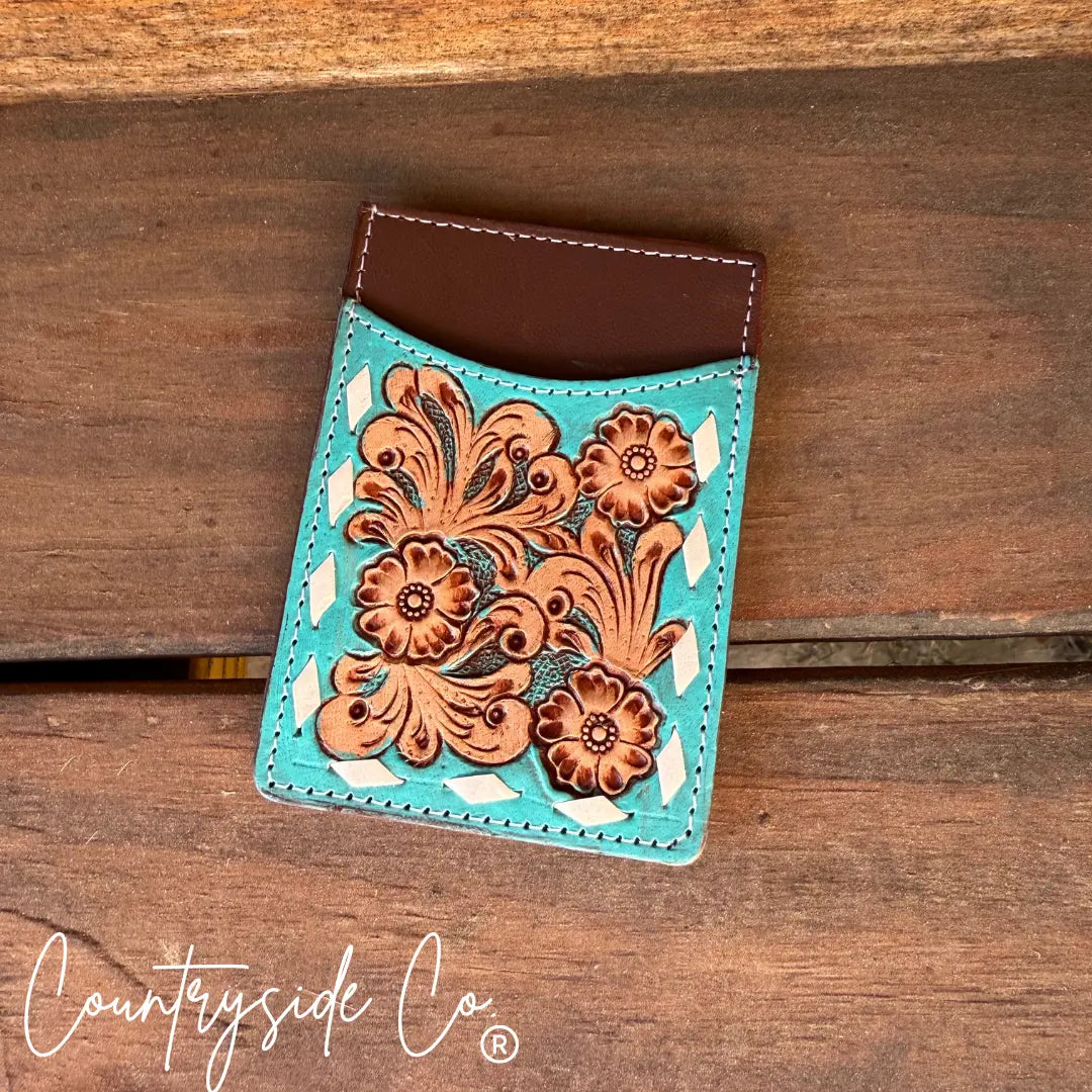Turquoise tooled leather credit card holder with floral pattern and brown leather top.