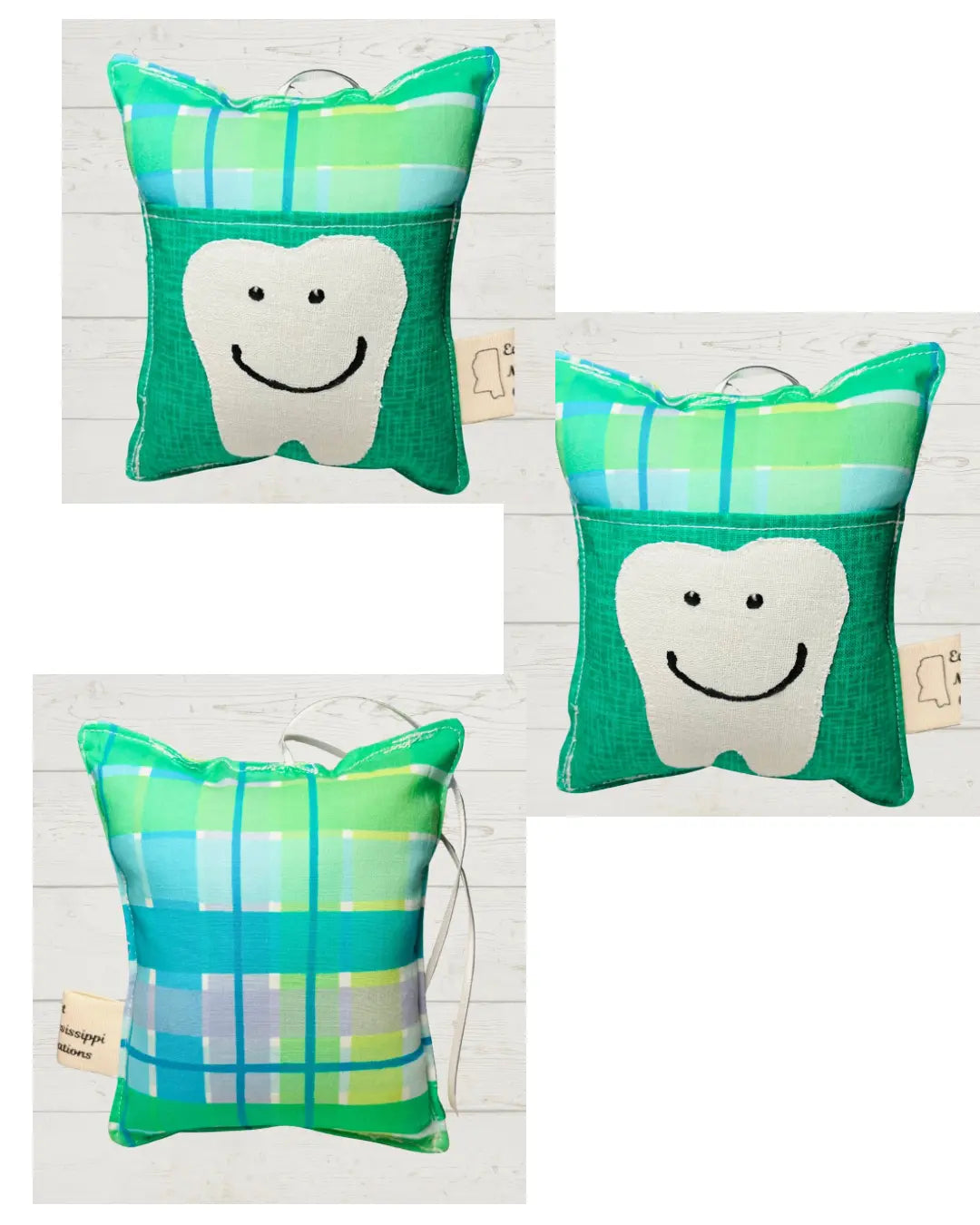 Handmade tooth fairy pillow with a smiling tooth design and pocket in green cotton fabric.