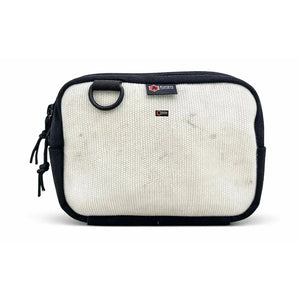 Off-white canvas fanny pack with black trim and a black D-ring.