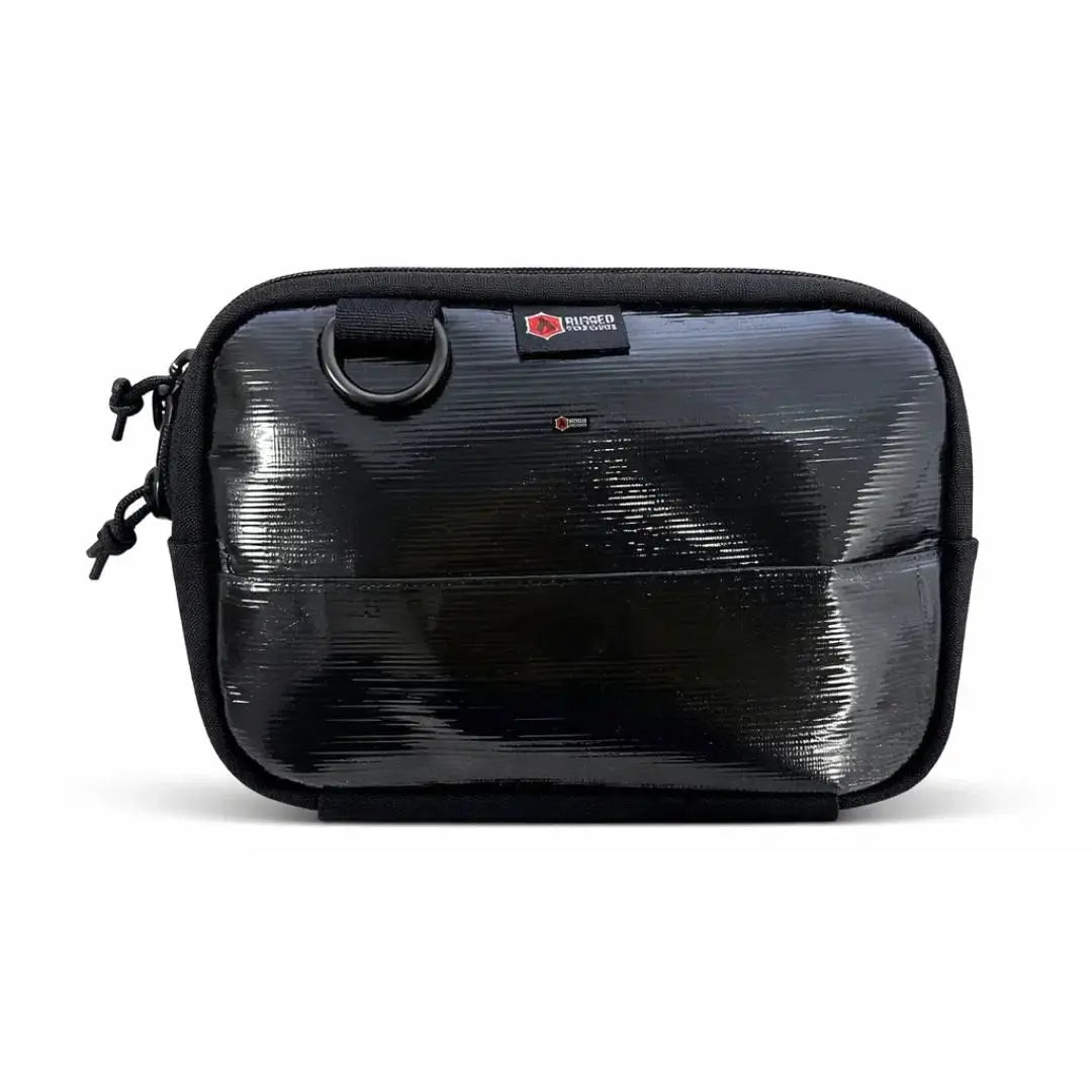Black shiny rectangular fanny pack with a red logo patch and D-ring.