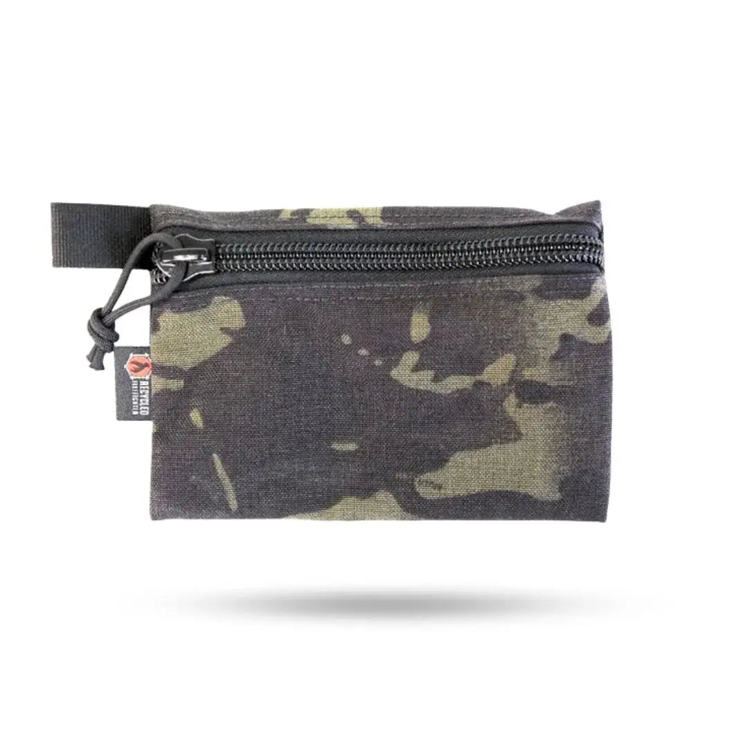 Multicam pouch with black zipper and black webbing loop.
