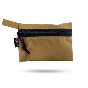 Tan zippered pouch with black zipper and recycled firefighter gear tag