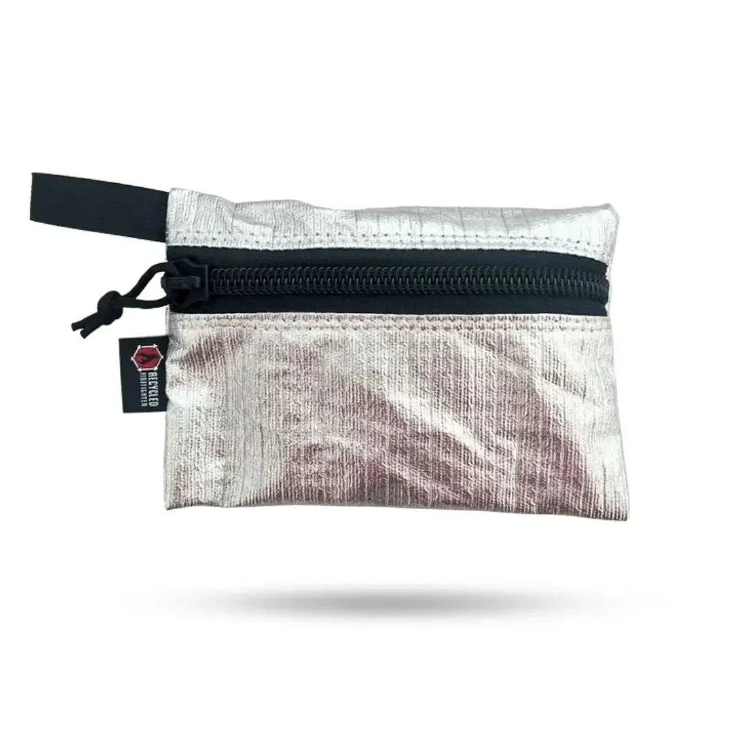 Silver zippered pouch with black zipper and a small black tag.
