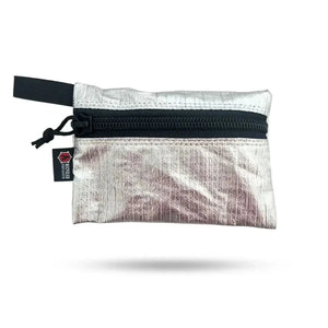 Silver zippered pouch with black zipper and a small black tag.
