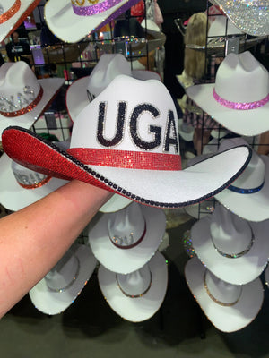 White cowboy hat with black and red rhinestones spelling UGA, red brim trim