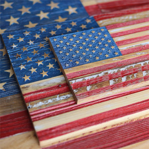 Wooden American flags with distressed red, white, and blue stripes and carved gold stars.