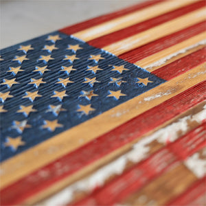 Close-up of a rustic wooden American flag with carved stars and stripes