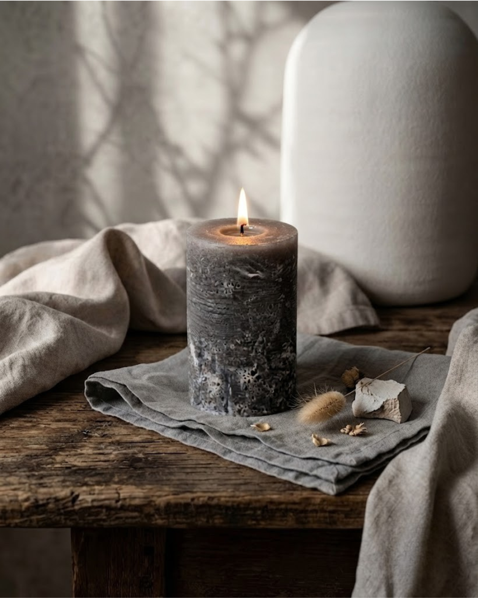 Gray textured pillar candle by Believe Candle shown upright