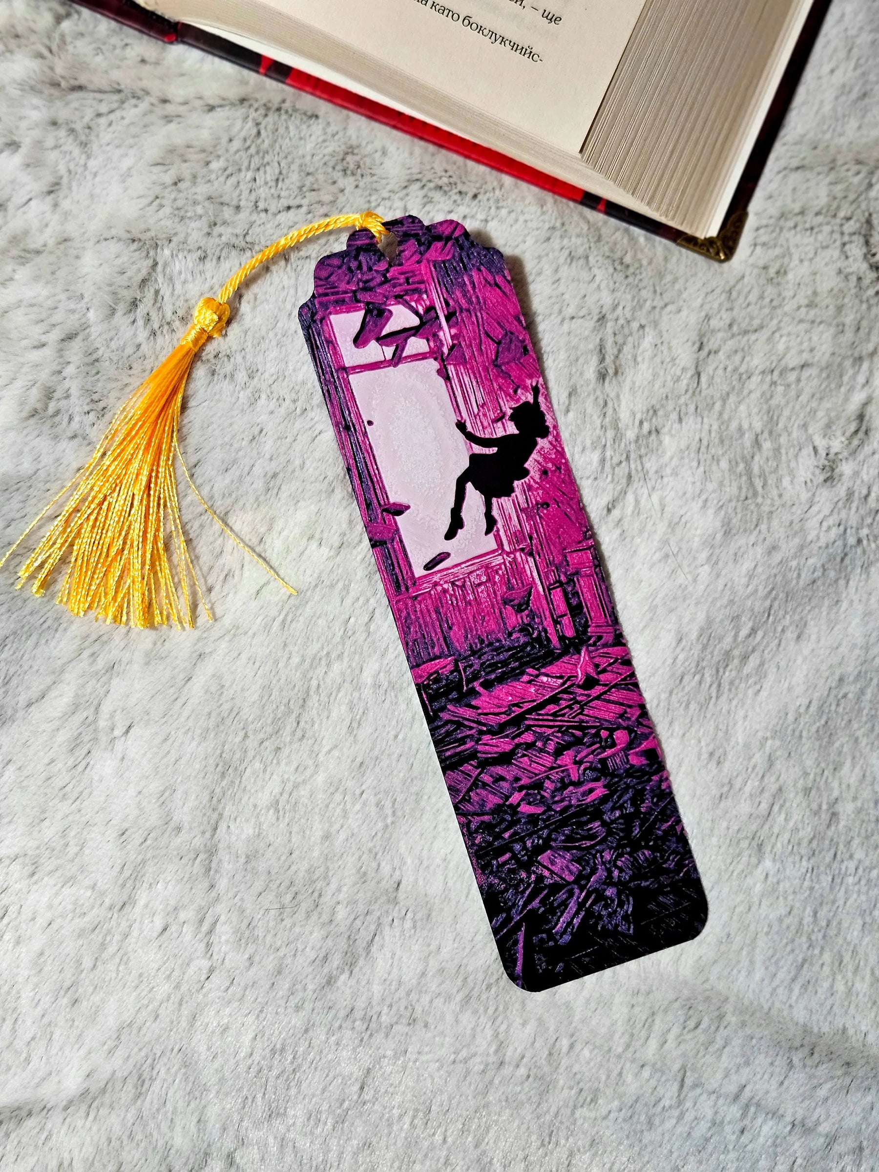 Bookmark featuring a silhouette falling through a shattered window; portal to a ruined room, neon purple, 80s supernatural theme.