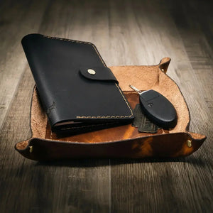 Black leather valet tray with wallet and car keys
