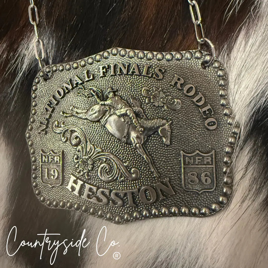 Vintage National Finals Rodeo buckle necklace with "Hesston 19 86" engraving