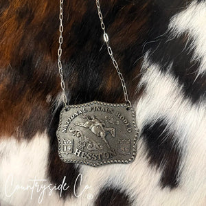 Silver NFR buckle necklace with horse rider design and paperclip chain.