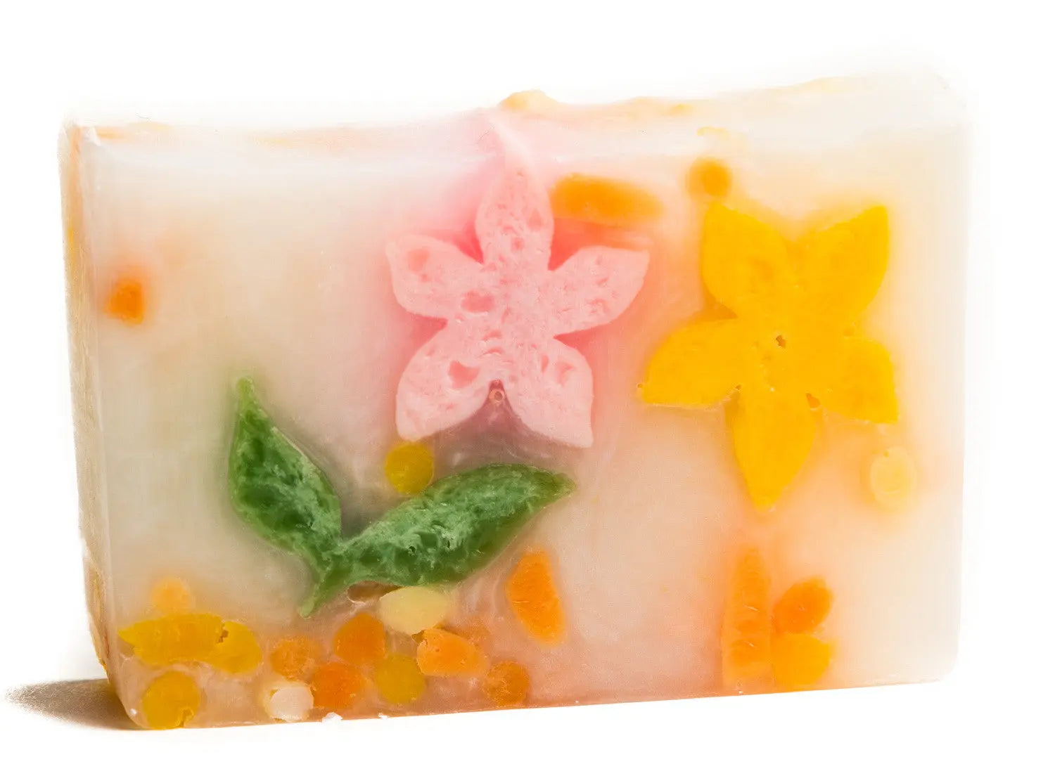 Handmade clear soap slice with pink and yellow flower embeds and green leaves.