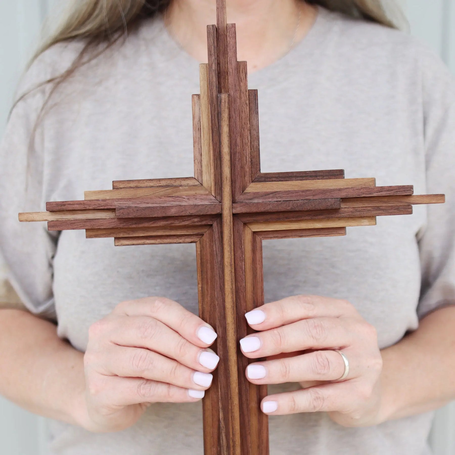 Layered wooden cross made of walnut.