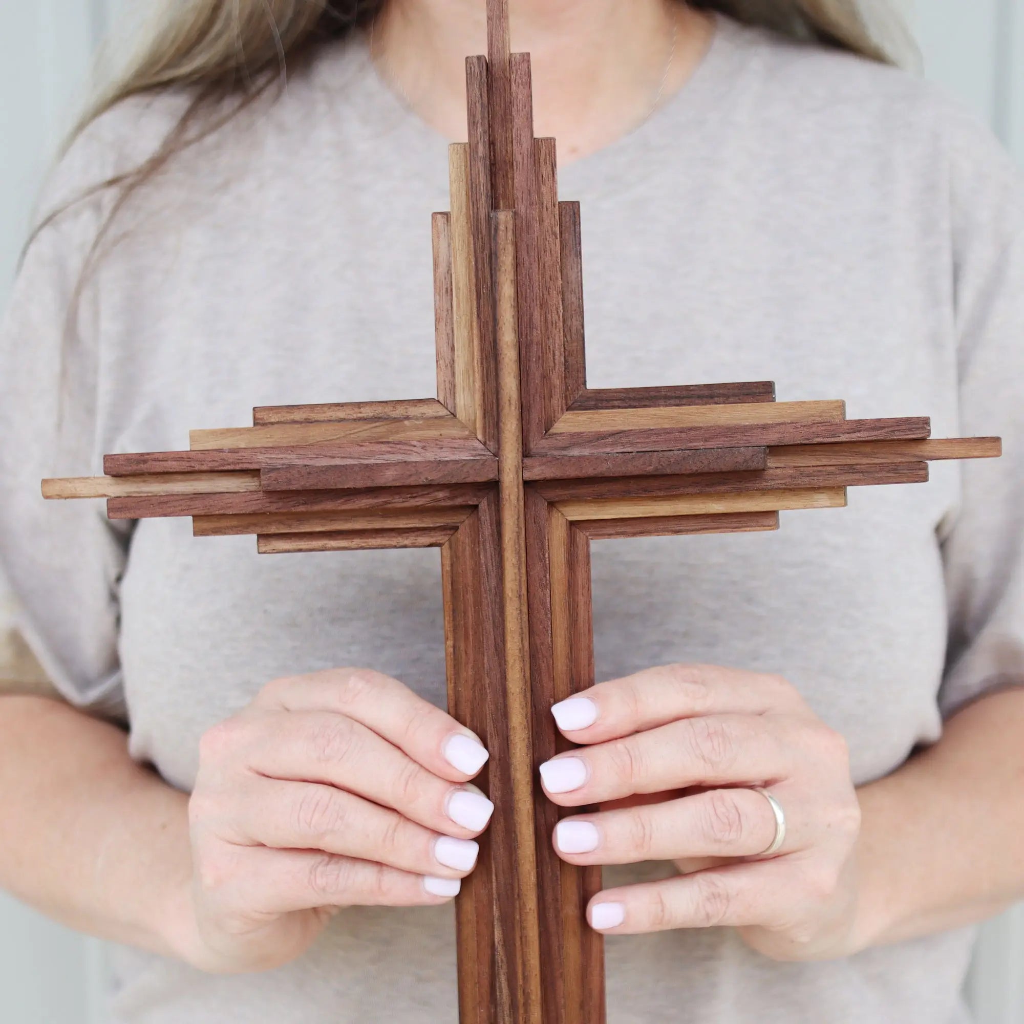 Layered wooden cross made of walnut.