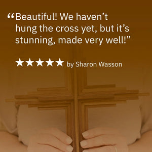 Wooden layered cross held by hands