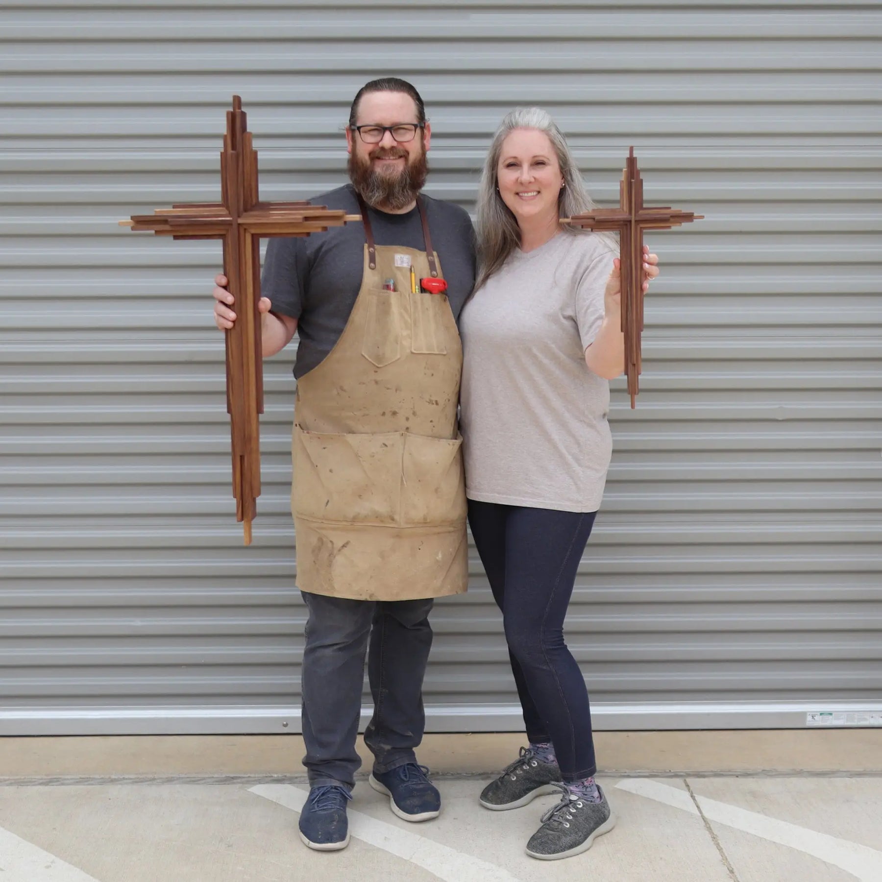 Walnut layered cross held by a man and a woman