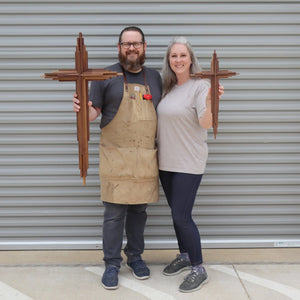 Walnut layered cross held by a man and a woman