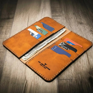 Tan leather Western Long Wallet holding cash and cards.