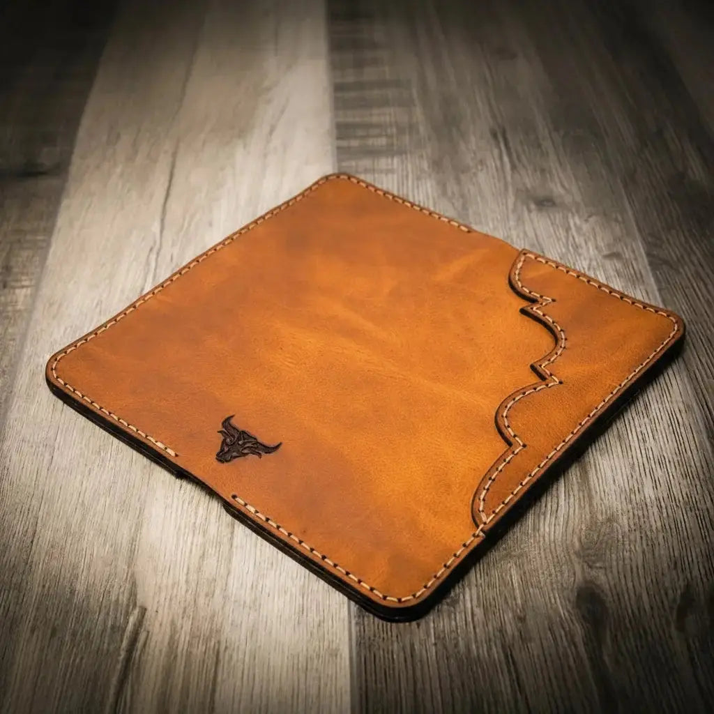 Brown leather Western long wallet with a bull emblem and decorative stitching.