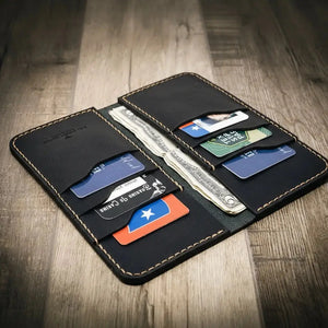 Black leather bifold wallet with multiple card slots and cash