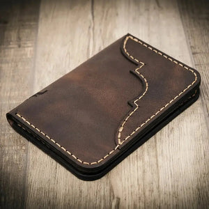 Brown leather bifold wallet with decorative stitching and vertical card slots.