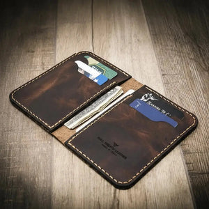 Brown leather western vertical wallet with card slots and cash pockets.
